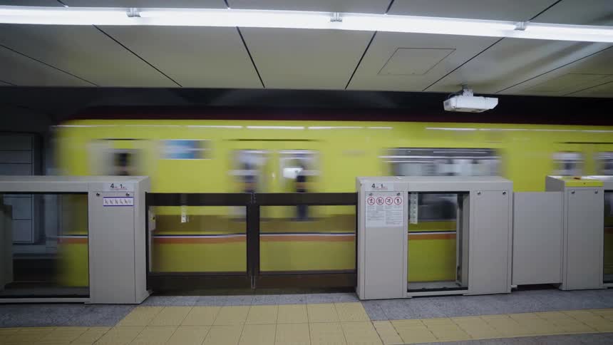 Yellow train passes through an underground subway