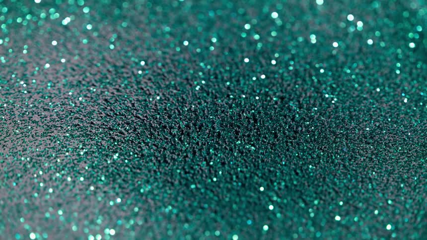 Iron Filings and green glitter move and reflect light
