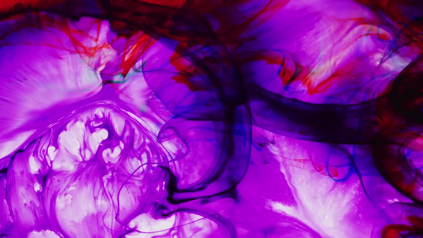 Mixture of bright colors mixing together and slowly swirling around