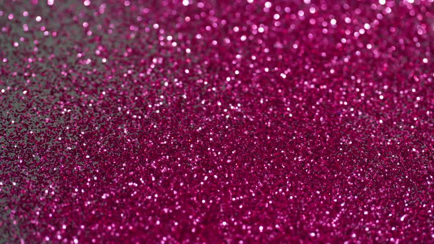 The surface is covered with purple glitter and creates a complex bokeh