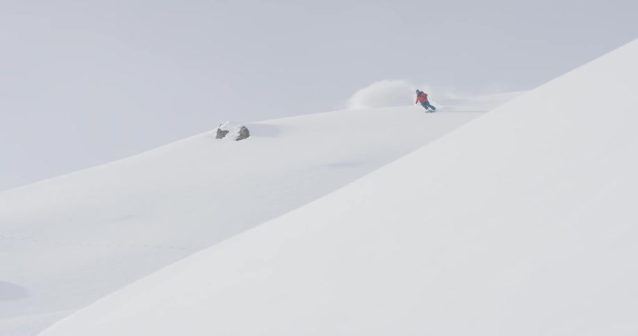 The skier turns fast moving down the slope