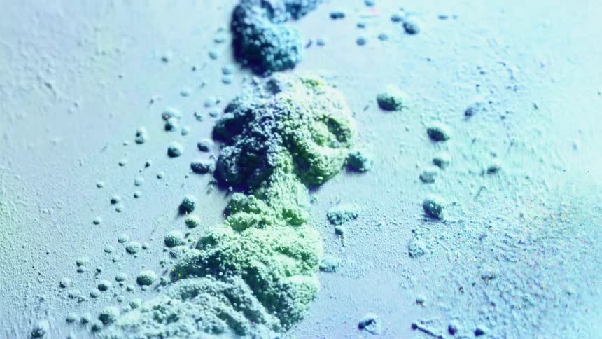 Blue and green sand vibrate in piles