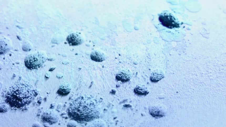 Holi powder moves and vibrates on a plate in a cymatic pattern