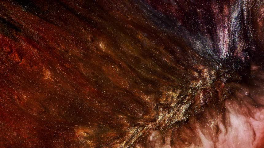 Brownish metallic swirls of liquid pour downwards