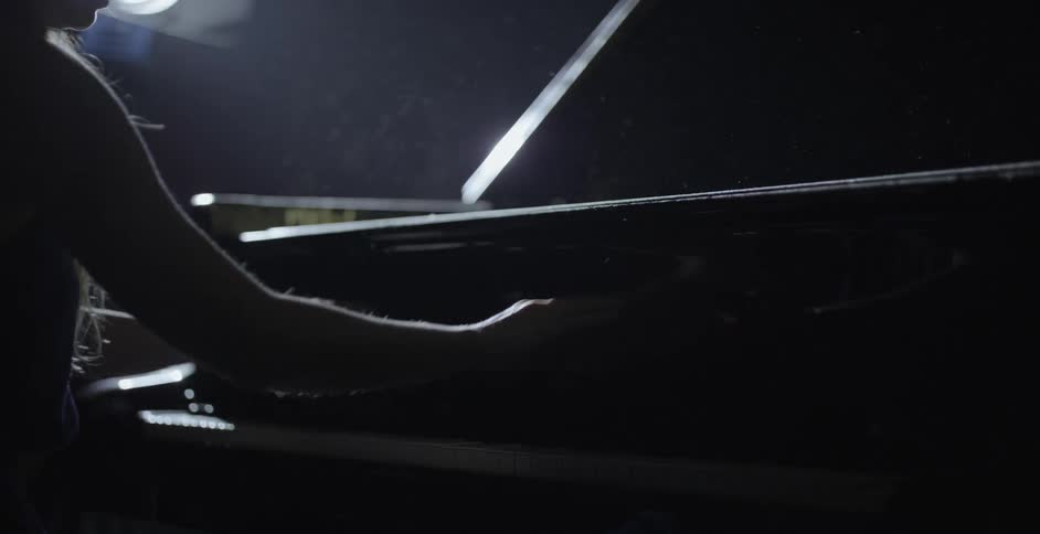 Person opens the top of a piano