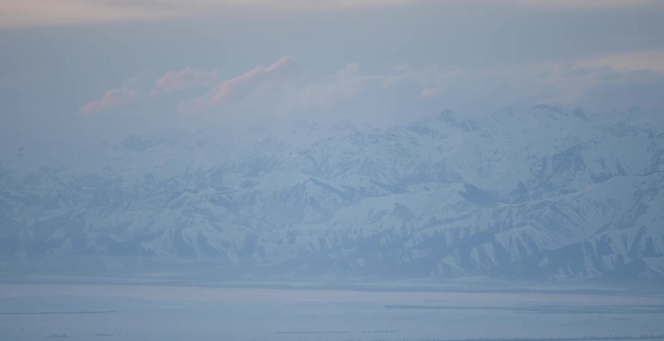 Clouds pass above the snow covered landscape