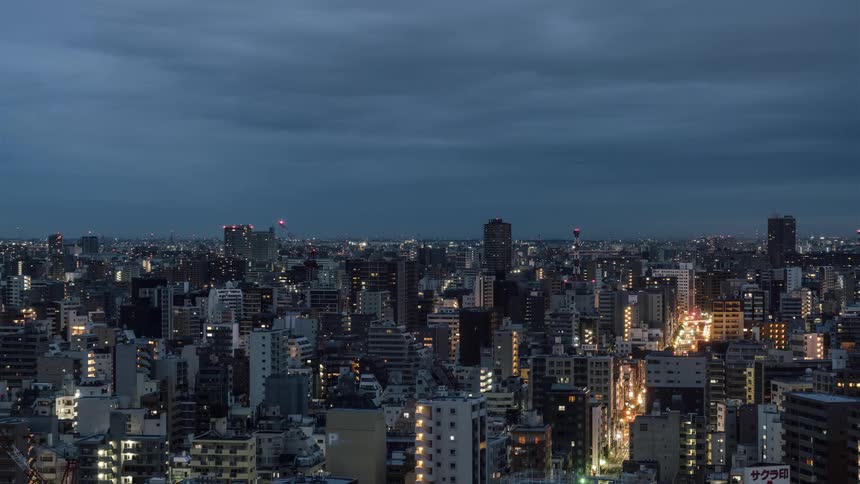 Time-lapse of  a large city from night to day on a cloudy day