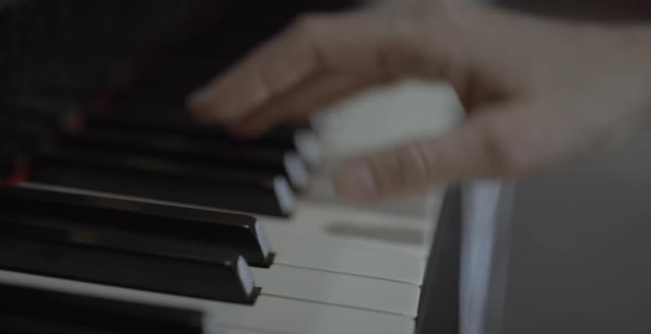 Woman plays a piano by pressing the keys