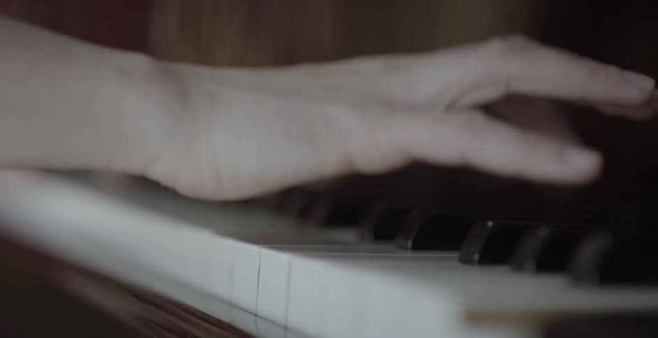 Person's hands hit piano keys