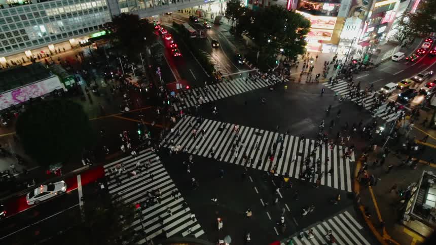 Pedestrians cross a large intersection in several directions