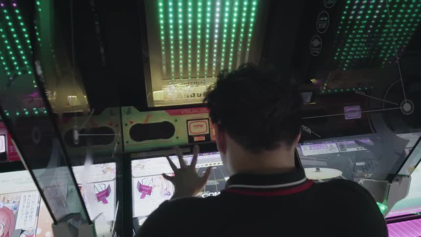 A man plays on an arcade game