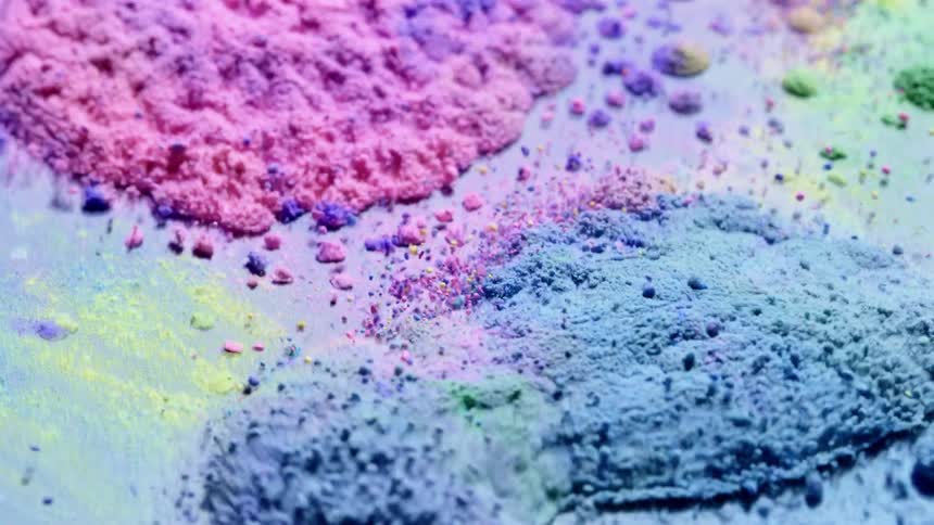 Colored granules are vibrating and bouncing on a surface