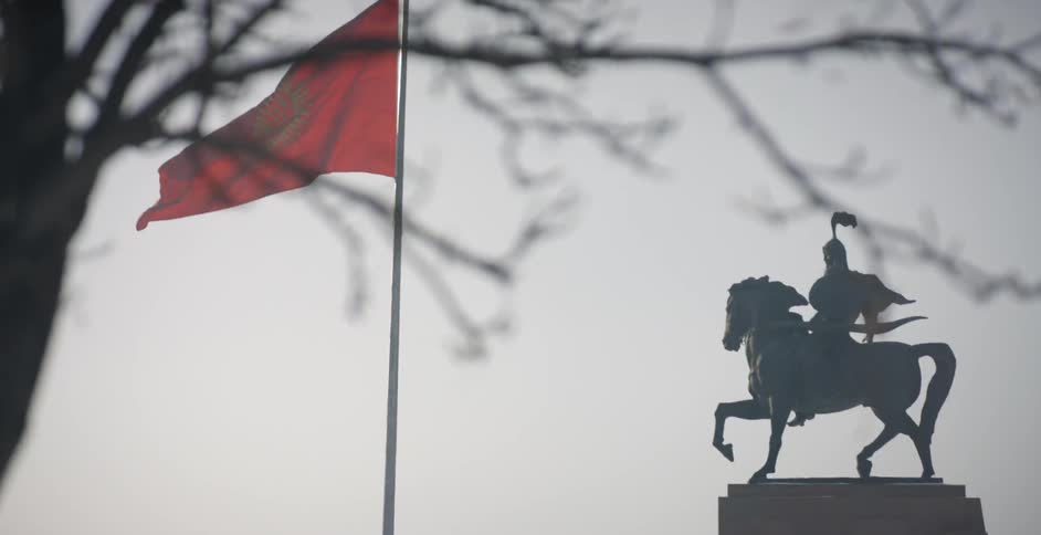 The red flag blows in the windy sky