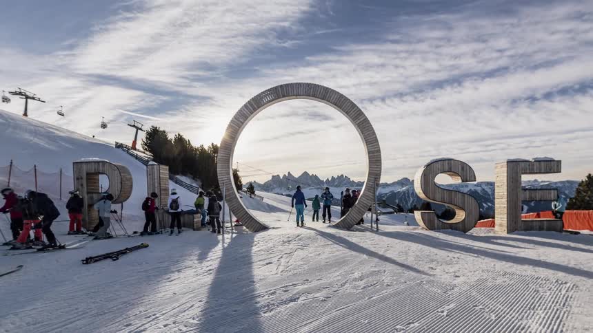 People are traveling through a circle on the ski slope