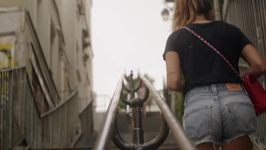 A woman walks up stairs