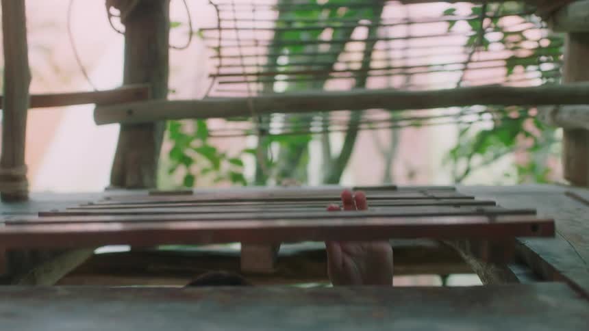 A woman shuts the door to a tree house