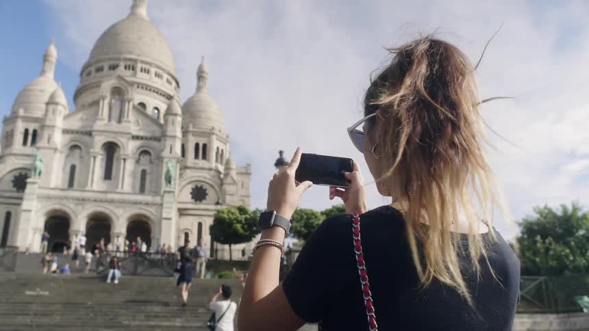 A woman photographs with her phone