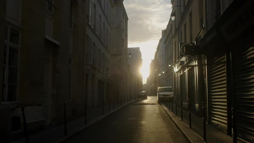 The sun sets over a city street