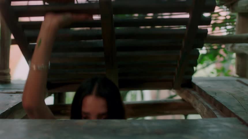 Woman opens hatch and climbs out of the opening