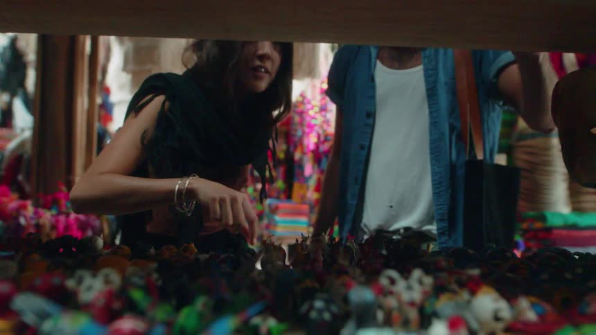 A man and woman shop in a market
