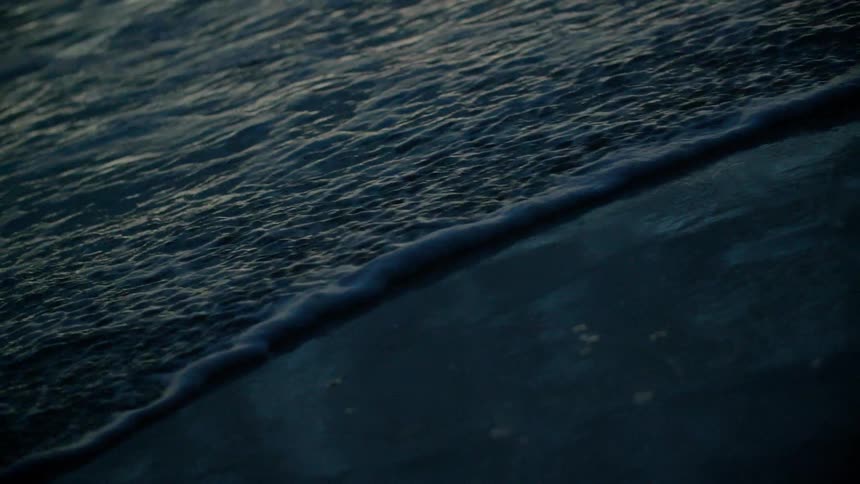 Waves flow onto the beach shore