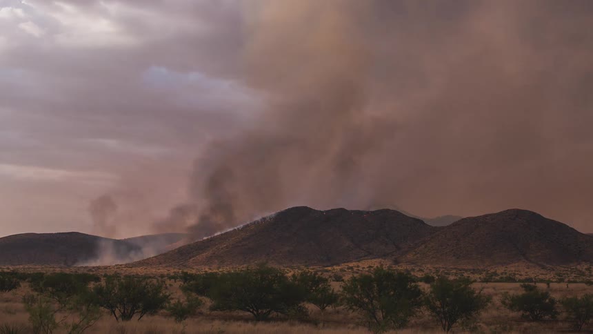 A fire burns in the desert