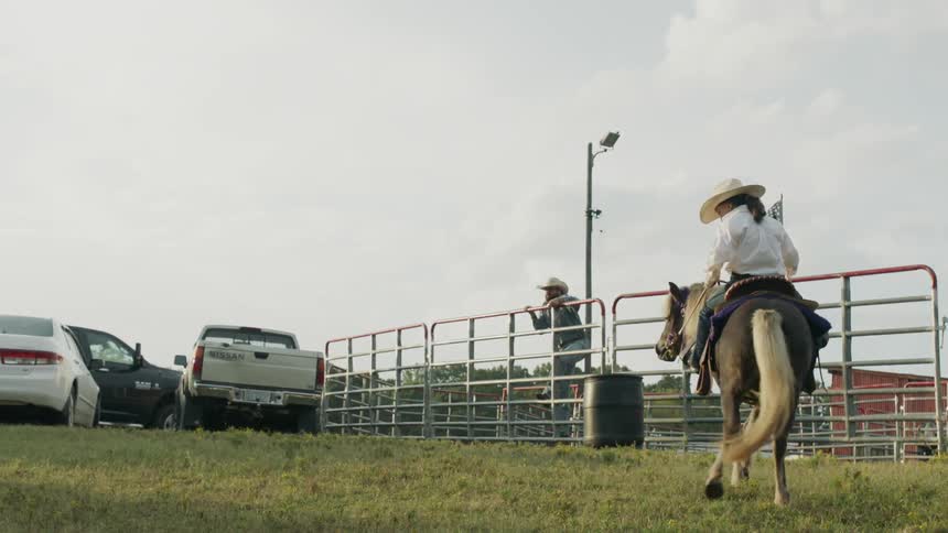 A young child rides on a small horse