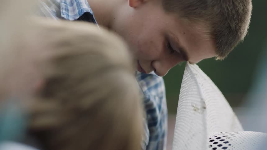 Man stares intently with his head tilted down