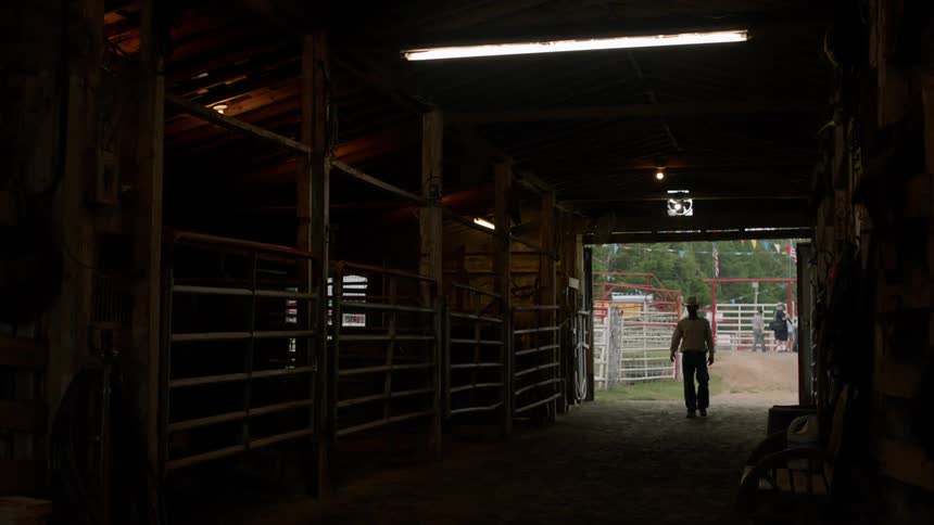 A man walks into a stable