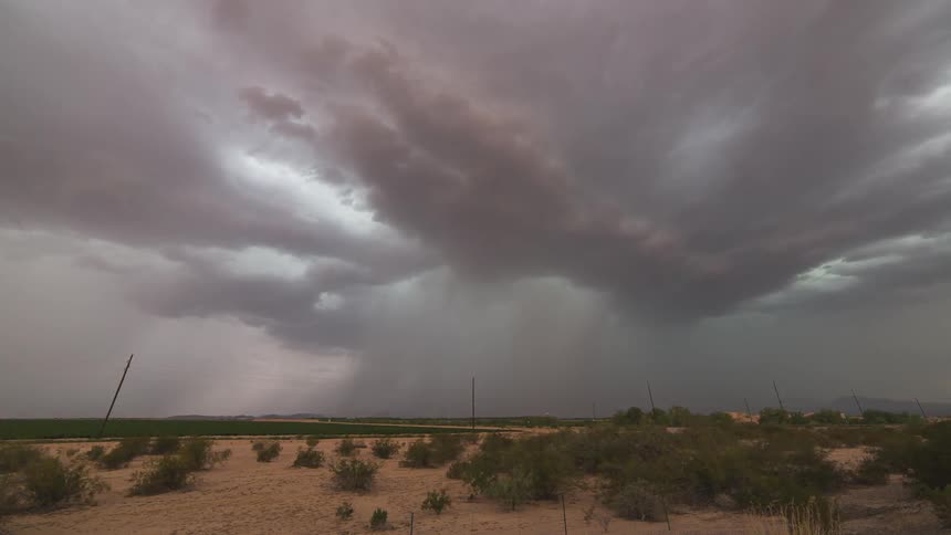 Time lapse of storm clouds moving over a plain