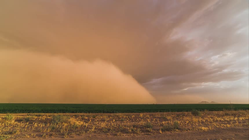 A storm in timelapse over farmland