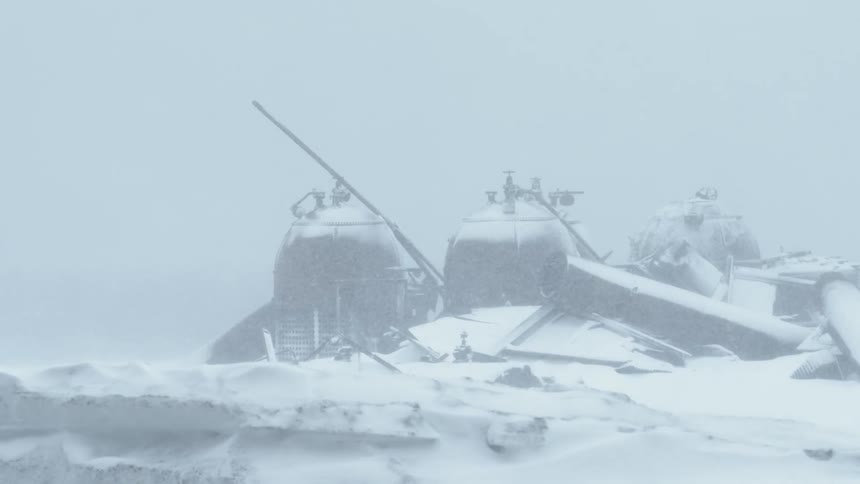 Snow falls rapidly onto old metal structures