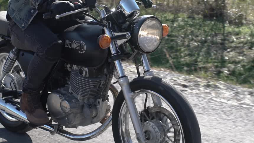 A motorcycle travels down the road