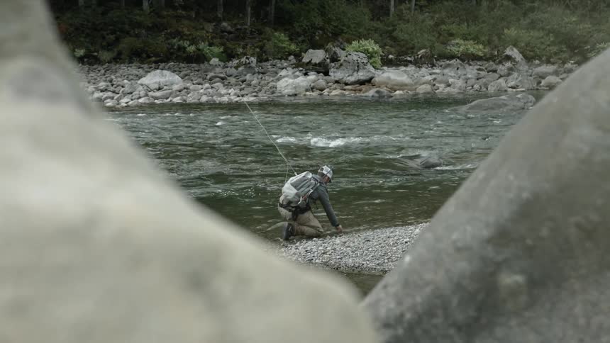 A man fishes in a stream