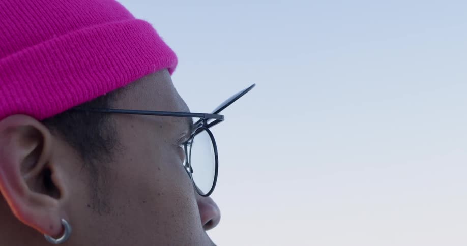 A man wears flip top sunglasses outside