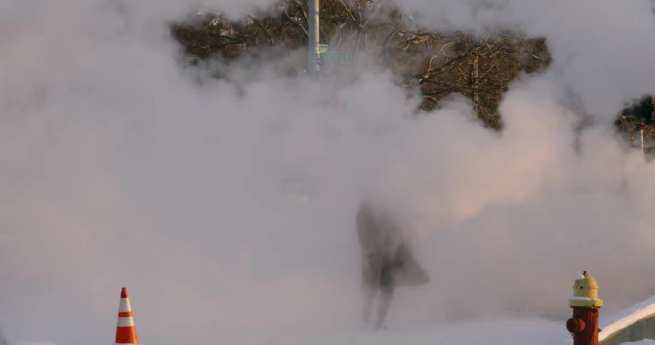 A man dances in a cloud of steam