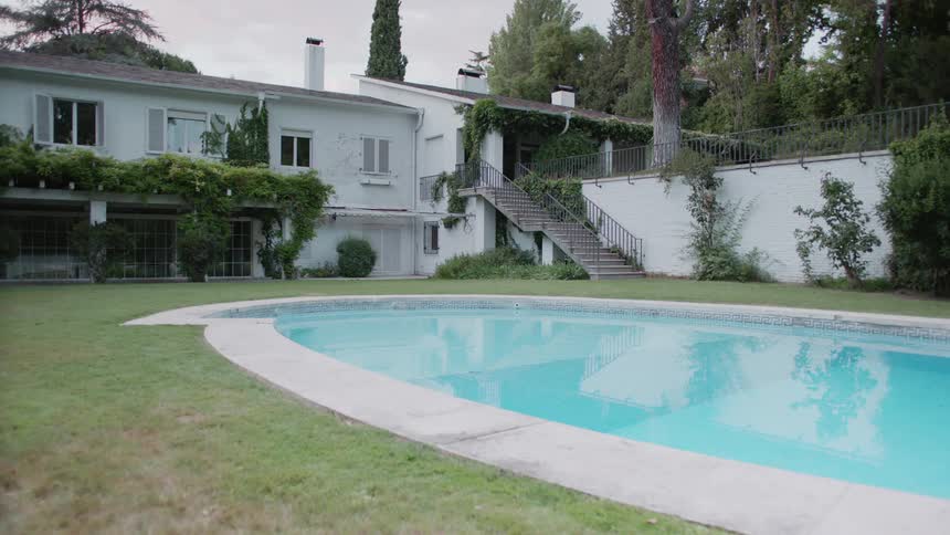 Pool water flows gently in the backyard of a house