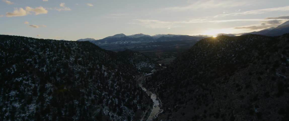 A valley stretches between two mountains