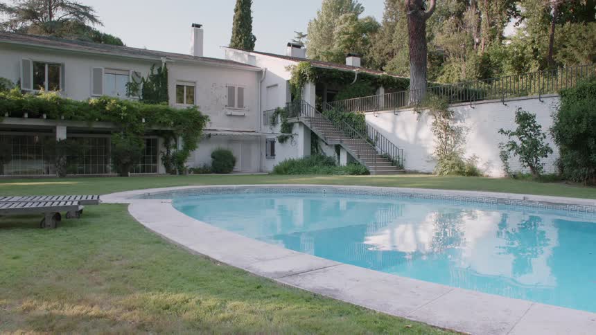 Pool water flows gently in the backyard of a house