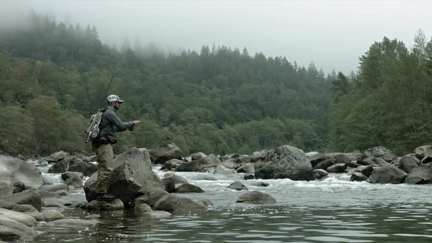 A man fishes in a stream