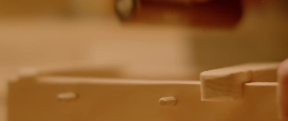Person sands wood with sandpaper