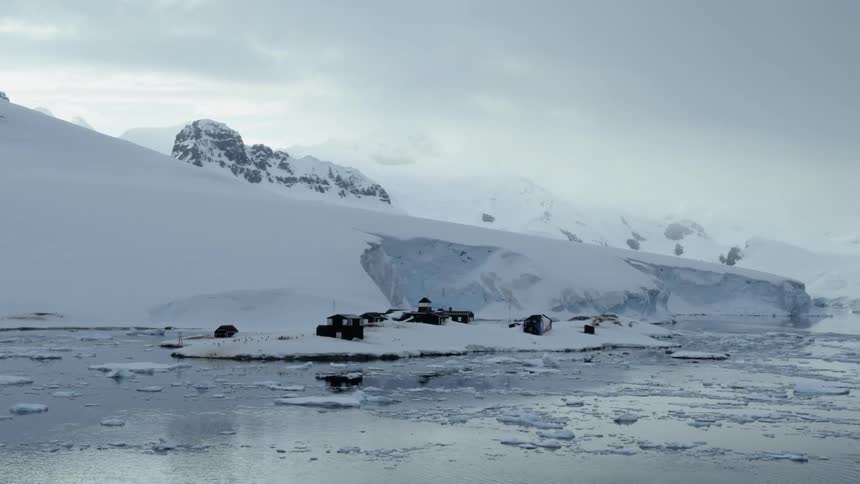 Passing an snowy antarctic research station on a ship