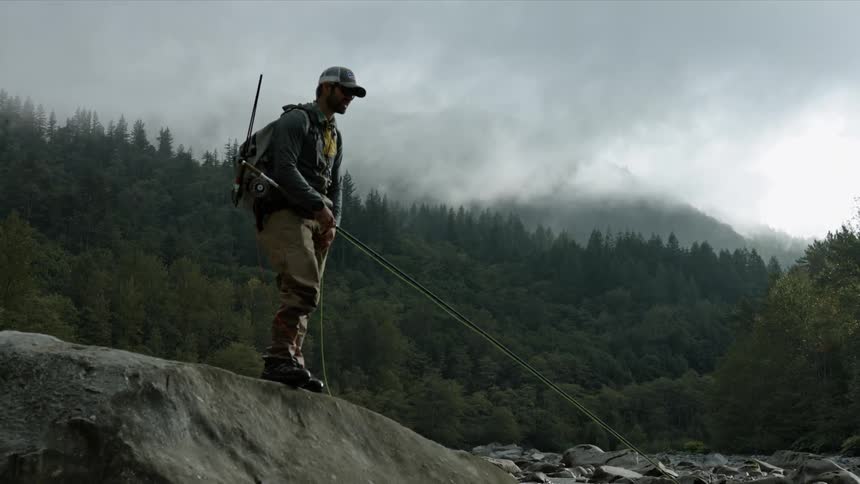 A man fishes in a stream