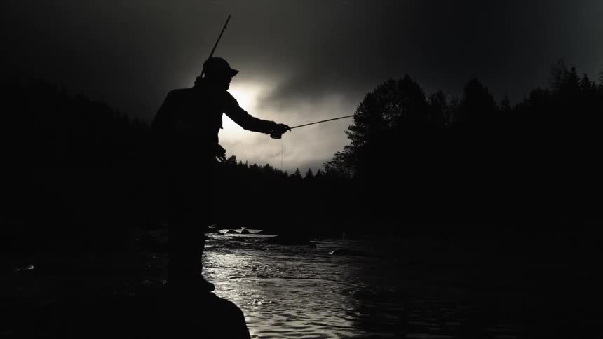 A man fishes in a stream