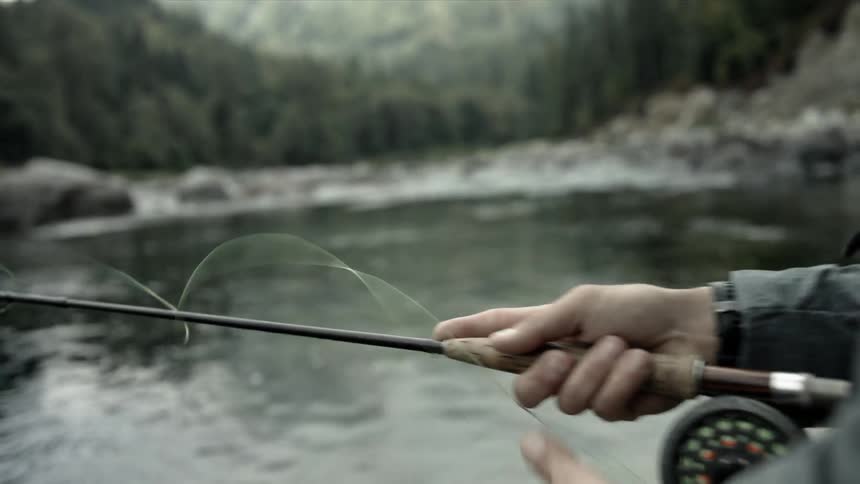 A man fishes in a stream