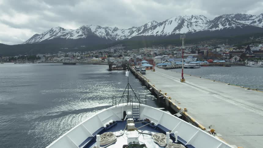 A large boat sits docked on the water