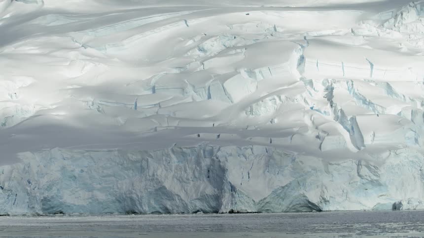 Snow covers icy ridge at ocean's edge