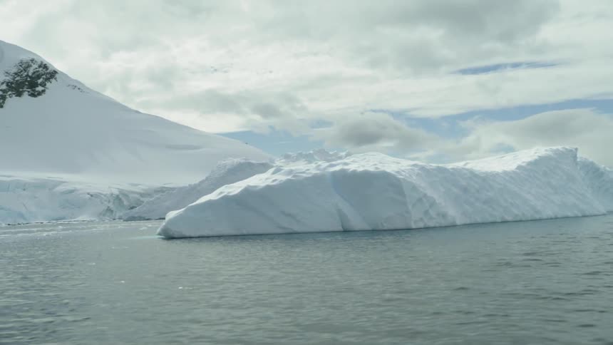 Icebergs floating in cold water on a cloudy day