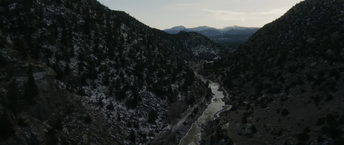 A river flows through mountains in winter