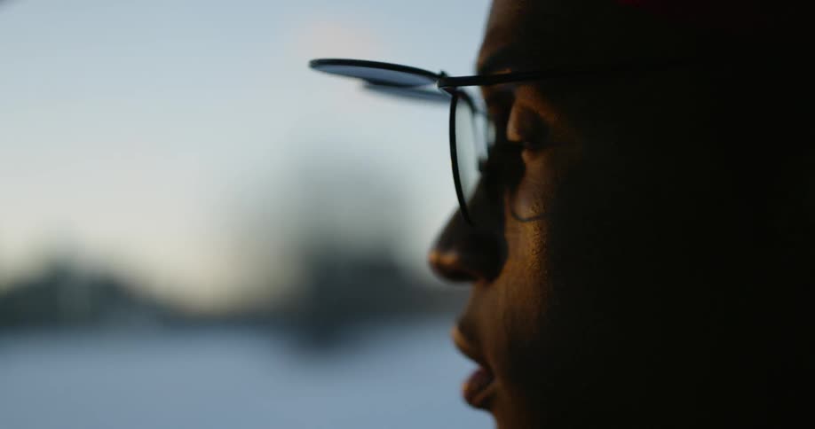 A man with flip up glasses looks around